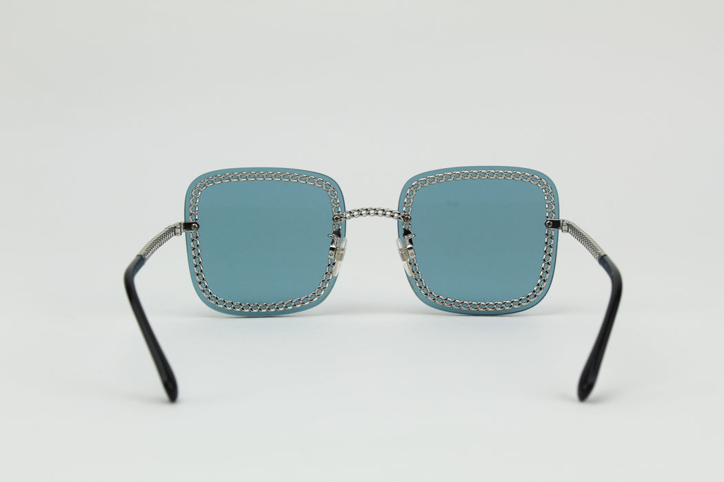 Chanel blue square chain around sunglasses